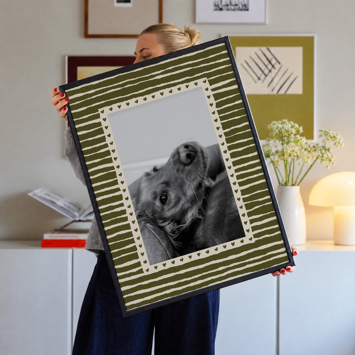 Hearts custom pet photo print in Olive Green, in a black frame, held up in a living room, with an example photo