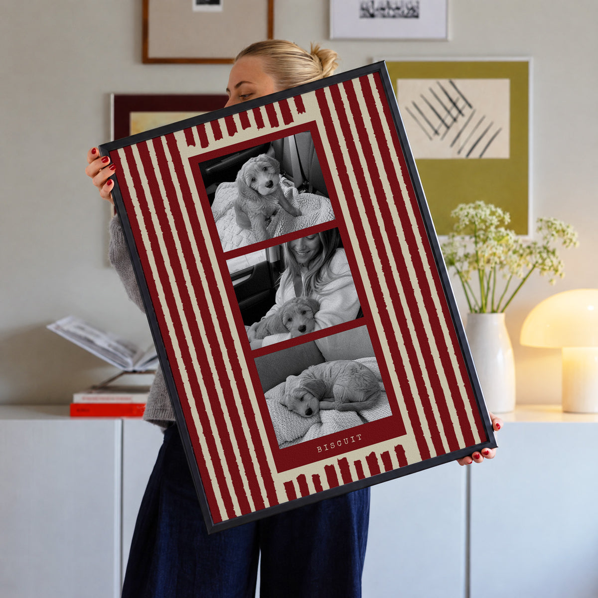 Photo strip custom pet photo print in Cherry Red, in a black frame, held up in a living room